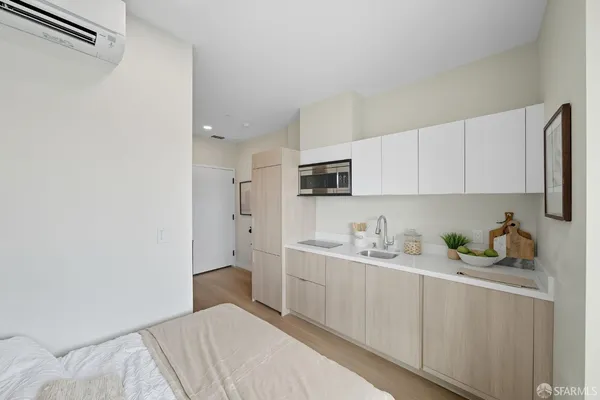 a bedroom with a bed and cabinets