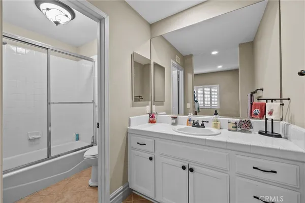 a kitchen with kitchen island granite countertop a sink appliances and cabinets