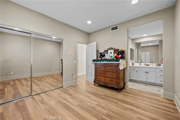 a kitchen with stainless steel appliances granite countertop a stove top oven a sink dishwasher and a dining table with wooden floor