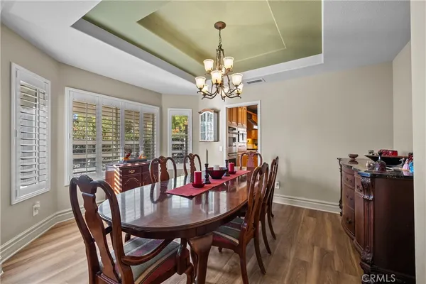 a view of a dining room with furniture and chandelier