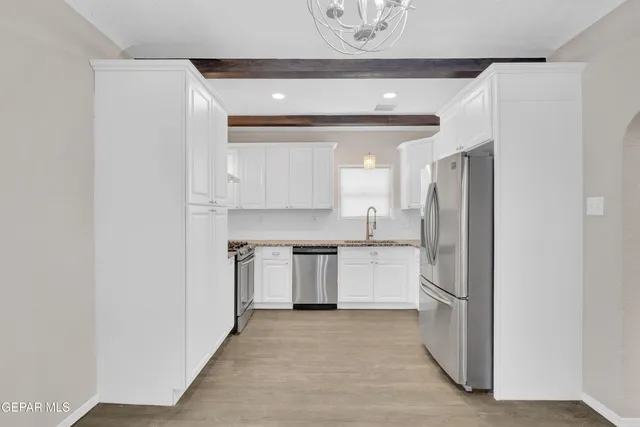 a kitchen with a refrigerator and a stove top oven