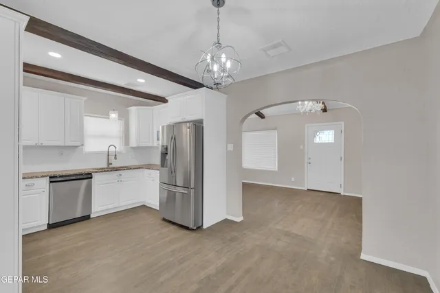a view of a kitchen with a sink and stainless steel appliances