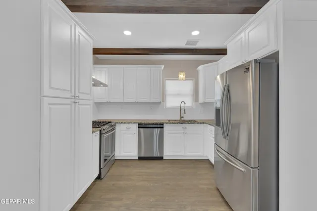 a kitchen with a refrigerator and a sink