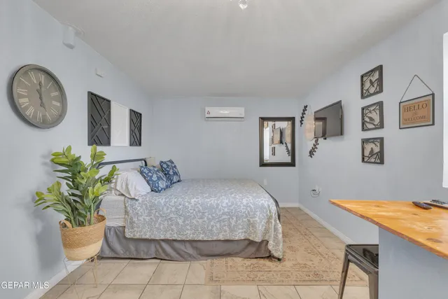 a bedroom with a bed and a table