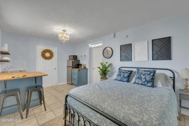 a bedroom with a bed and a desk