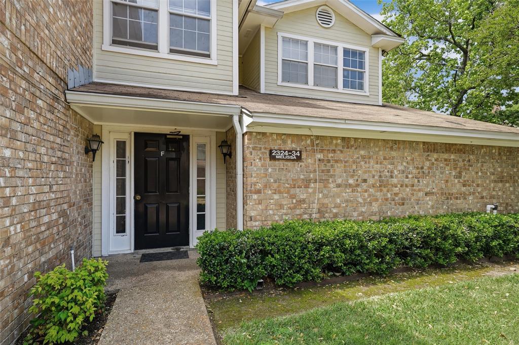 Entrance to property with brick siding