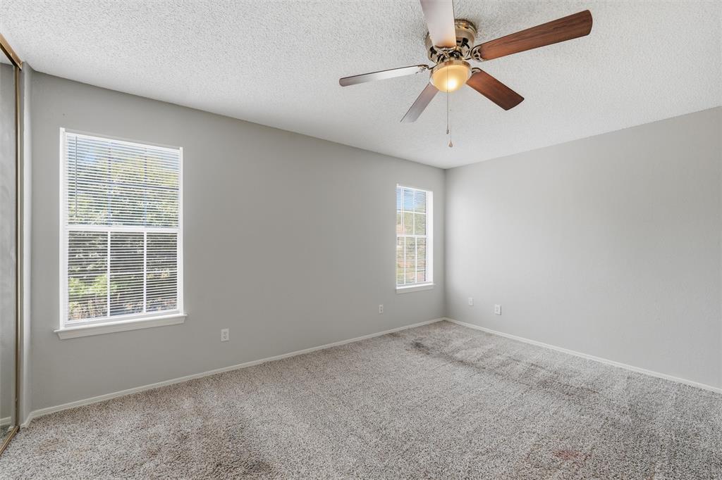 2332 Melissa Drive Waco, TX 76708 - Photo 12 of 15 Spare room featuring carpet, a ceiling fan, and a textured ceiling