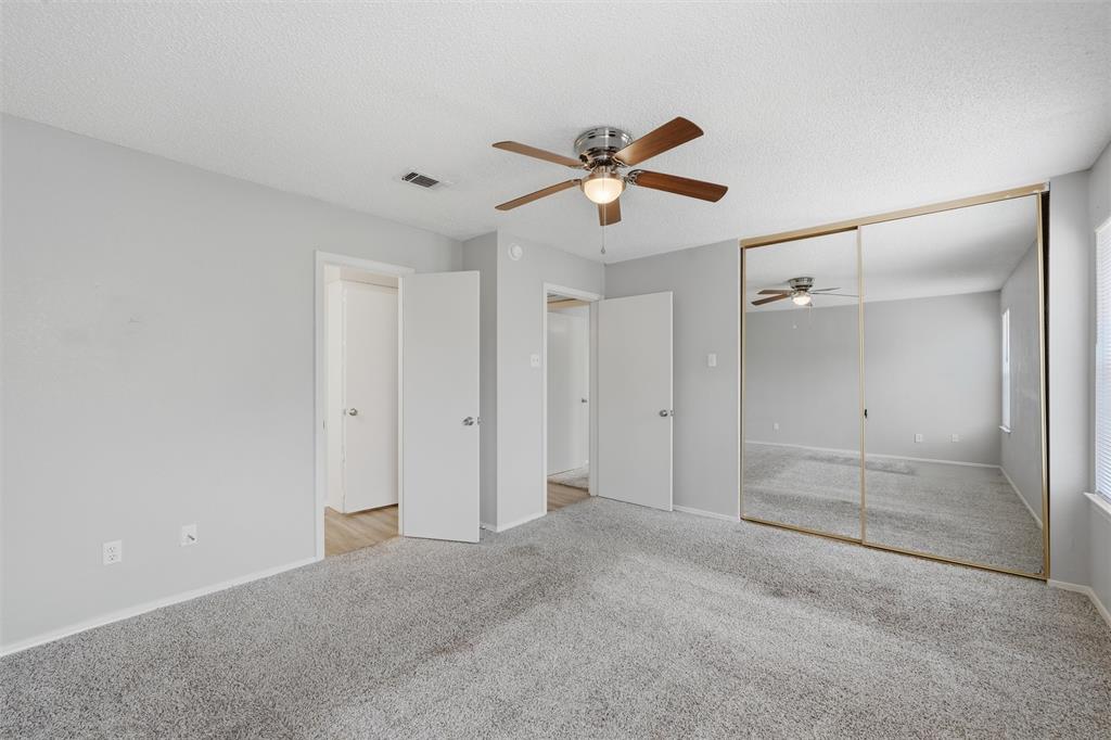 2332 Melissa Drive Waco, TX 76708 - Photo 13 of 15 Unfurnished bedroom with light colored carpet, a ceiling fan, a textured ceiling, and a closet