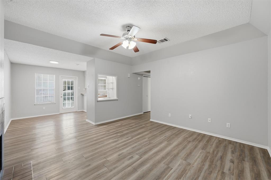 2332 Melissa Drive Waco, TX 76708 - Photo 3 of 15 Empty room with a textured ceiling, ceiling fan, and light wood finished floors