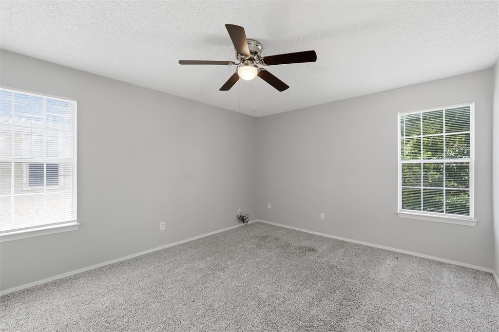 2332 Melissa Drive Waco, TX 76708 - Photo 9 of 15 Unfurnished room featuring carpet floors, a textured ceiling, and a ceiling fan
