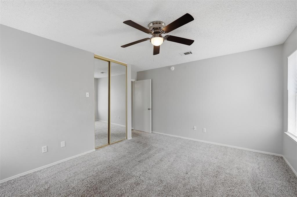 2332 Melissa Drive Waco, TX 76708 - Photo 10 of 15 Unfurnished bedroom with a textured ceiling, carpet flooring, a closet, and a ceiling fan