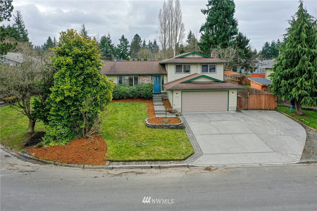 12931 Northeast 145th Place Kirkland, WA 98034 - Photo 1 of 1 a front view of a house with a garden