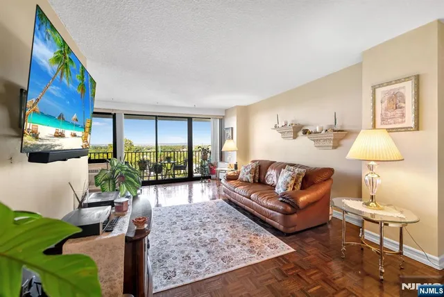 a living room with furniture large window and lamp