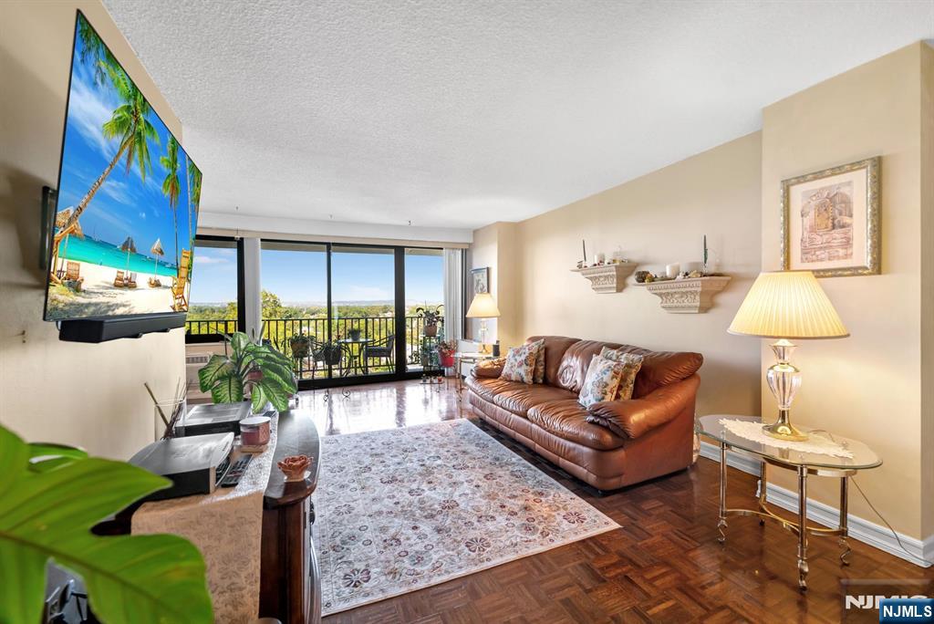 277 Prospect Avenue, Unit 10B Hackensack, NJ 07601 - Photo 11 of 34 a living room with furniture large window and lamp