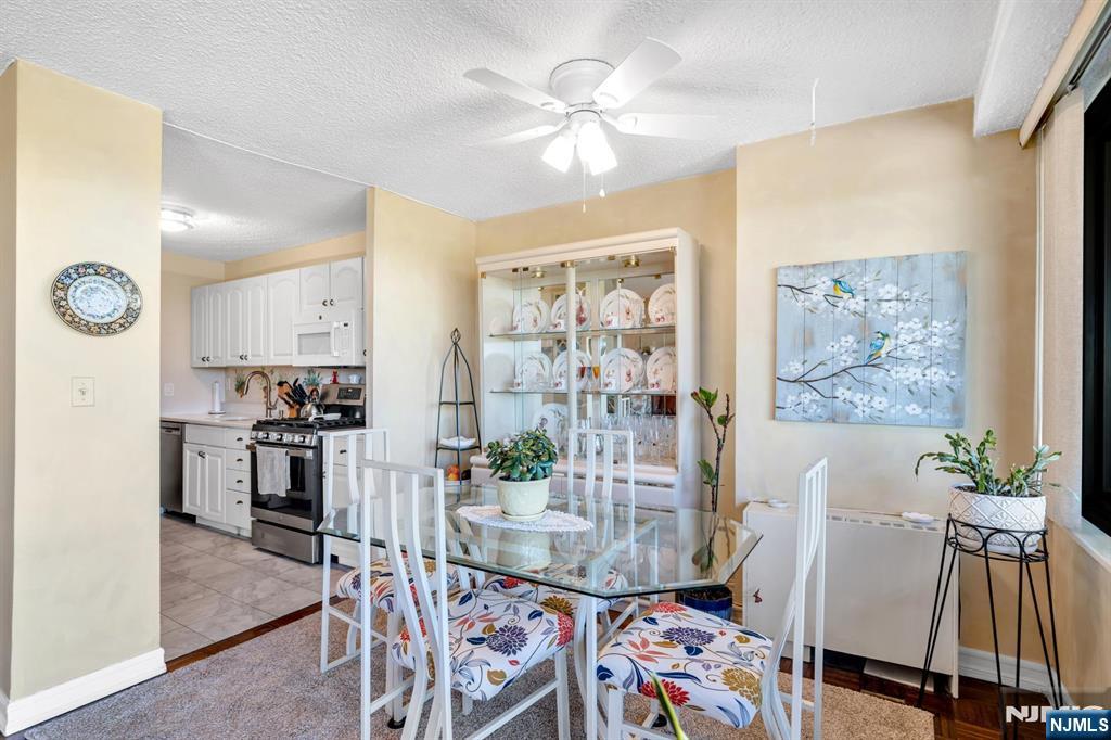 277 Prospect Avenue, Unit 10B Hackensack, NJ 07601 - Photo 13 of 34 a view of a dining room with furniture and wooden floor