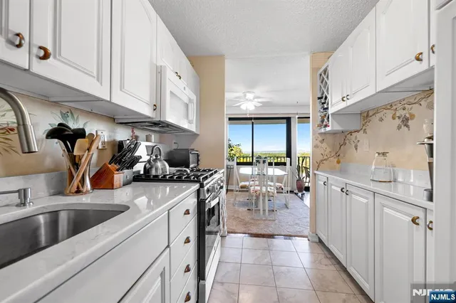 a kitchen with stainless steel appliances granite countertop a sink and cabinets