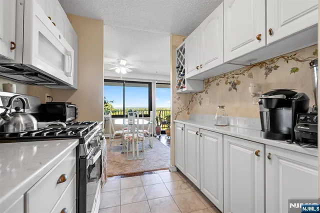 a kitchen with sink a stove and cabinets