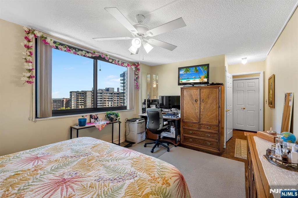 277 Prospect Avenue, Unit 10B Hackensack, NJ 07601 - Photo 2 of 34 a bedroom with furniture and a large window