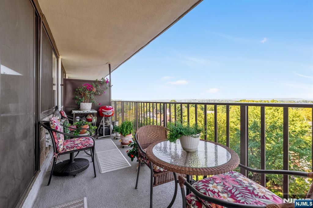 277 Prospect Avenue, Unit 10B Hackensack, NJ 07601 - Photo 22 of 34 a balcony with table and chairs