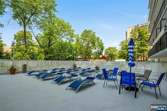 an outdoor sitting area with furniture and city view