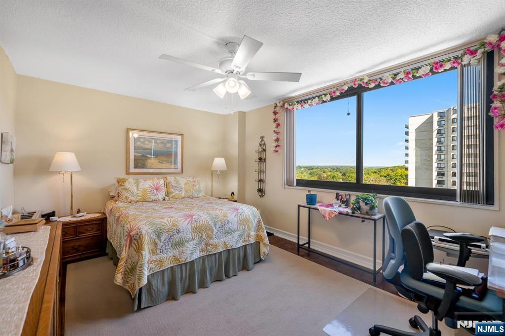 277 Prospect Avenue, Unit 10B Hackensack, NJ 07601 - Photo 3 of 34 a bedroom with a bed and a chandelier