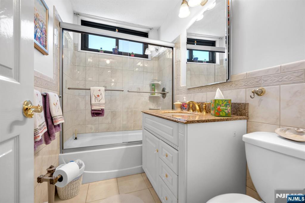 277 Prospect Avenue, Unit 10B Hackensack, NJ 07601 - Photo 6 of 34 a bathroom with a sink a toilet and shower