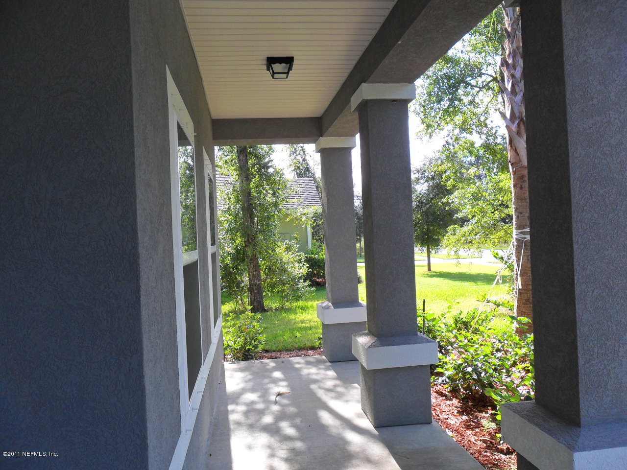 97218 Bluff View Circle, Unit ROSES BLUFF LOT 37 Yulee, FL 32097 - Photo 24 of 52 a front view of a house with garden