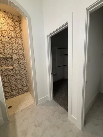 a bathroom with double vanity and a mirror