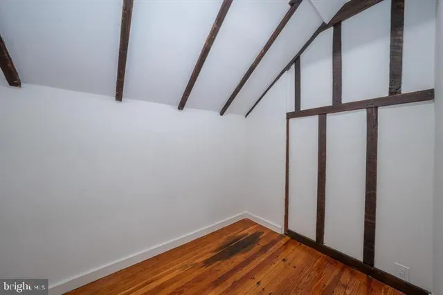 a view of small space with wooden floor and stairs
