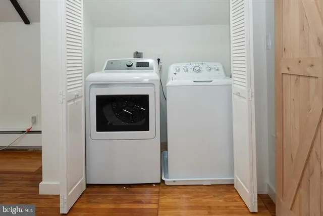 a view of washer and dryer with kitchen in the background