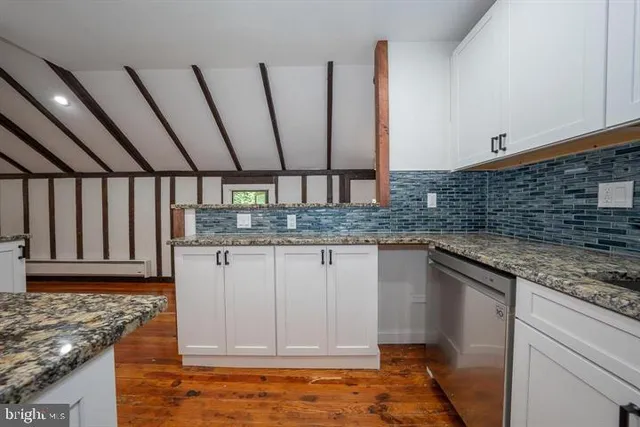 a kitchen with stainless steel appliances granite countertop a sink stove and cabinets