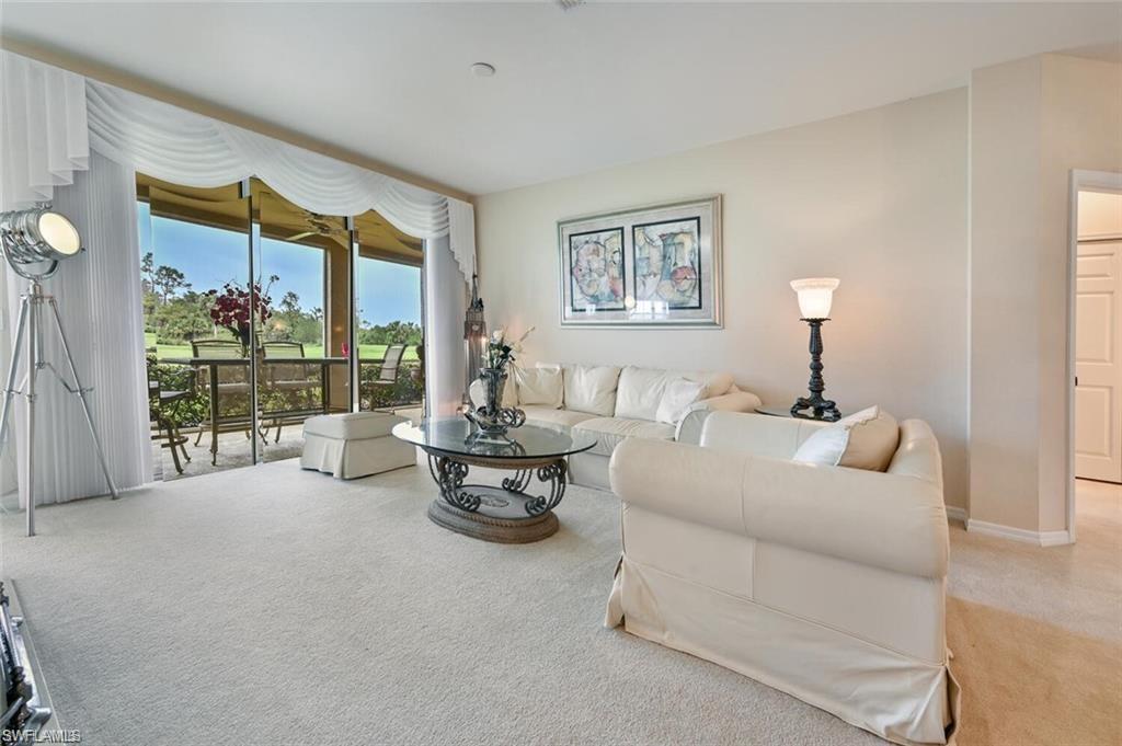 6065 Pinnacle Lane, Unit 1001 Naples, FL 34110 - Photo 13 of 26 a living room with furniture and a window