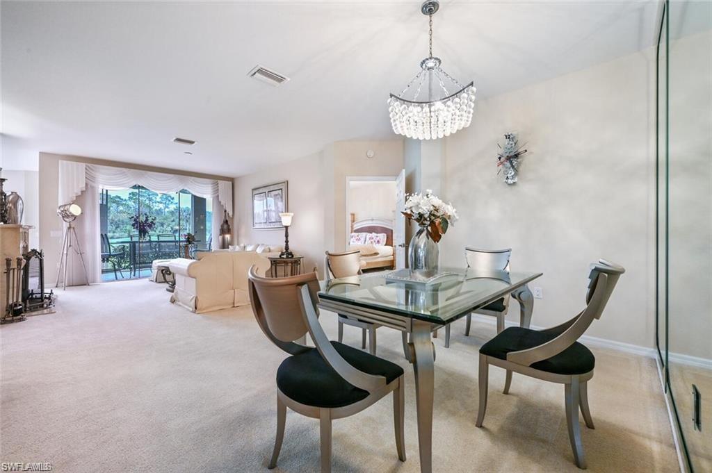 6065 Pinnacle Lane, Unit 1001 Naples, FL 34110 - Photo 15 of 26 a view of a dining room with furniture window and outside view