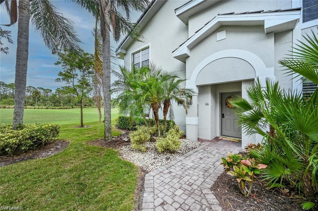 6065 Pinnacle Lane, Unit 1001 Naples, FL 34110 - Photo 4 of 26 a view of a house with a yard