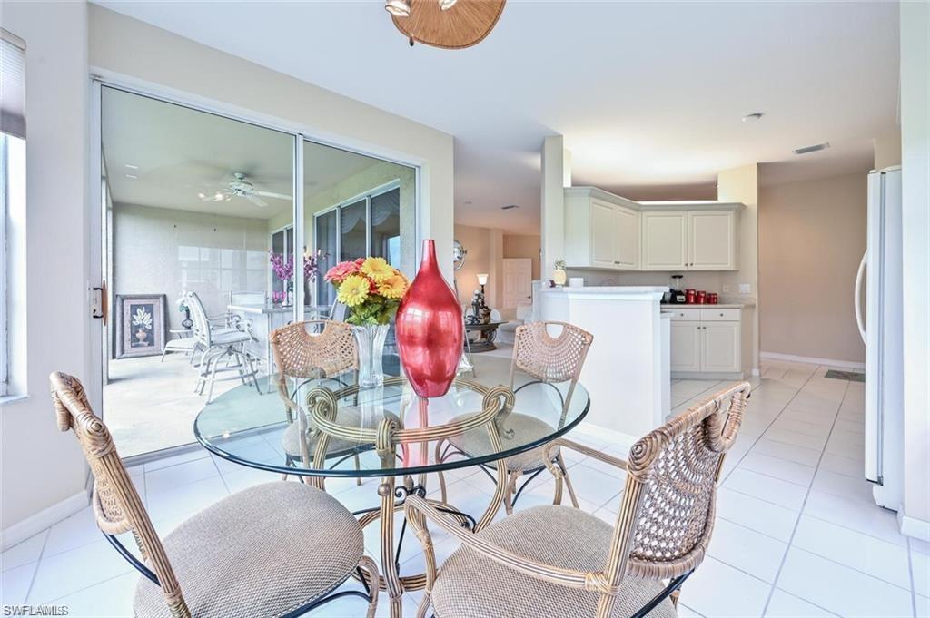 6065 Pinnacle Lane, Unit 1001 Naples, FL 34110 - Photo 8 of 26 a dining room with furniture and window