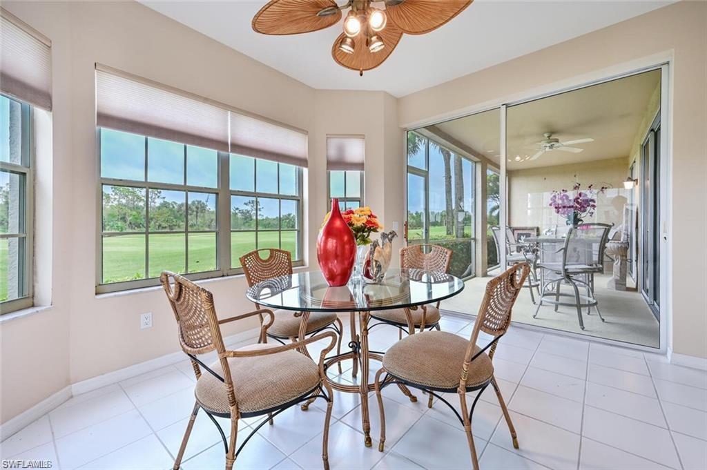 6065 Pinnacle Lane, Unit 1001 Naples, FL 34110 - Photo 9 of 26 a view of a dining room with furniture wooden floor and chandelier