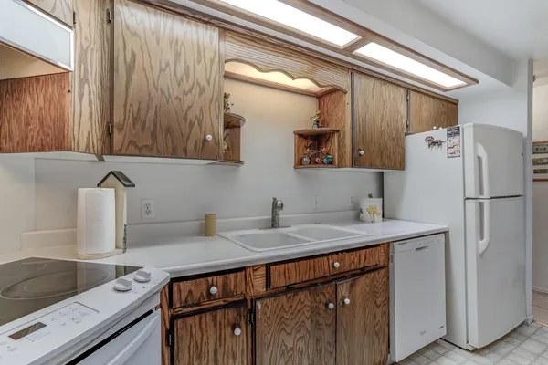 a en suite bathroom with a granite countertop sink and a mirror