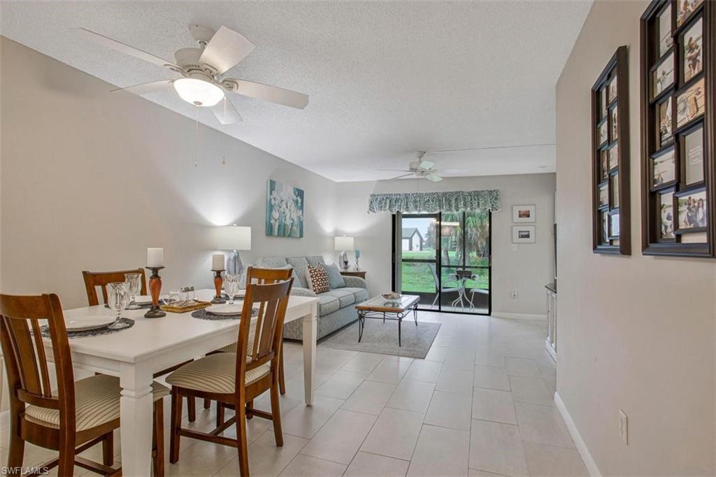 4258 27th Court Southwest, Unit 106 Naples, FL 34116 - Photo 4 of 19 Great room showing the dining area and living area with modern flooring through out