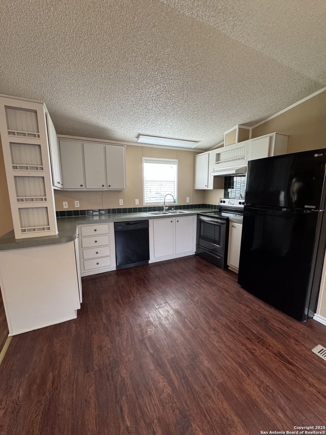 110 Deer Park Road, Unit B La Vernia, TX 78121 - Photo 5 of 12 a kitchen with granite countertop a refrigerator stove top oven and sink