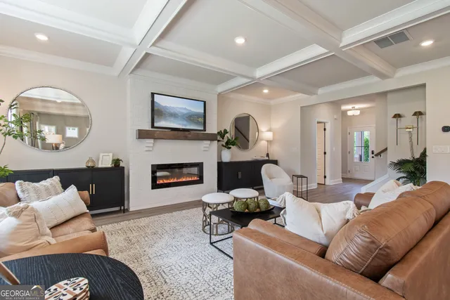 a living room with furniture flat screen tv and a fireplace
