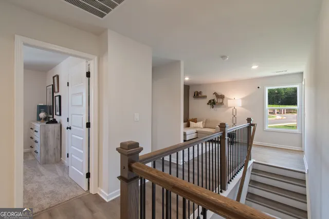 a bedroom with furniture and a wooden floor