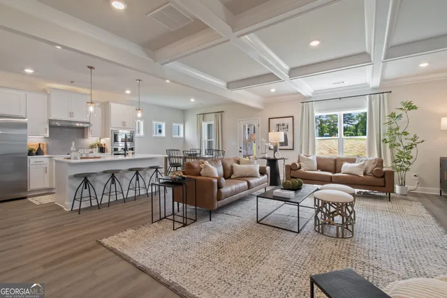 a living room with lots of furniture and kitchen view
