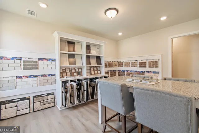 a living room with furniture and floor to ceiling windows