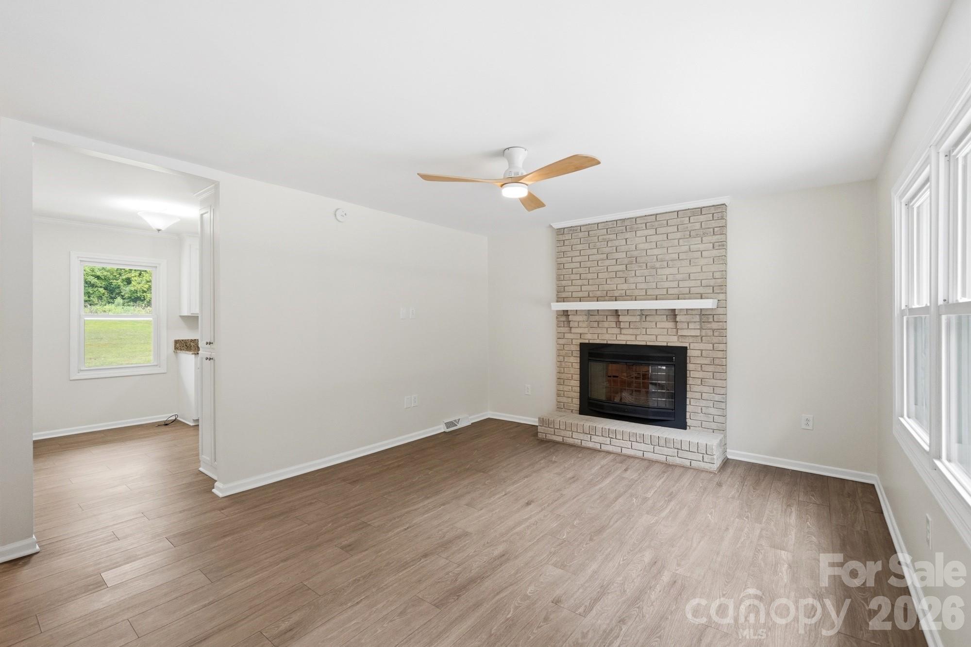 1235 Winecoff School Road Concord, NC 28027 - Photo 5 of 27 an empty room with windows and fireplace