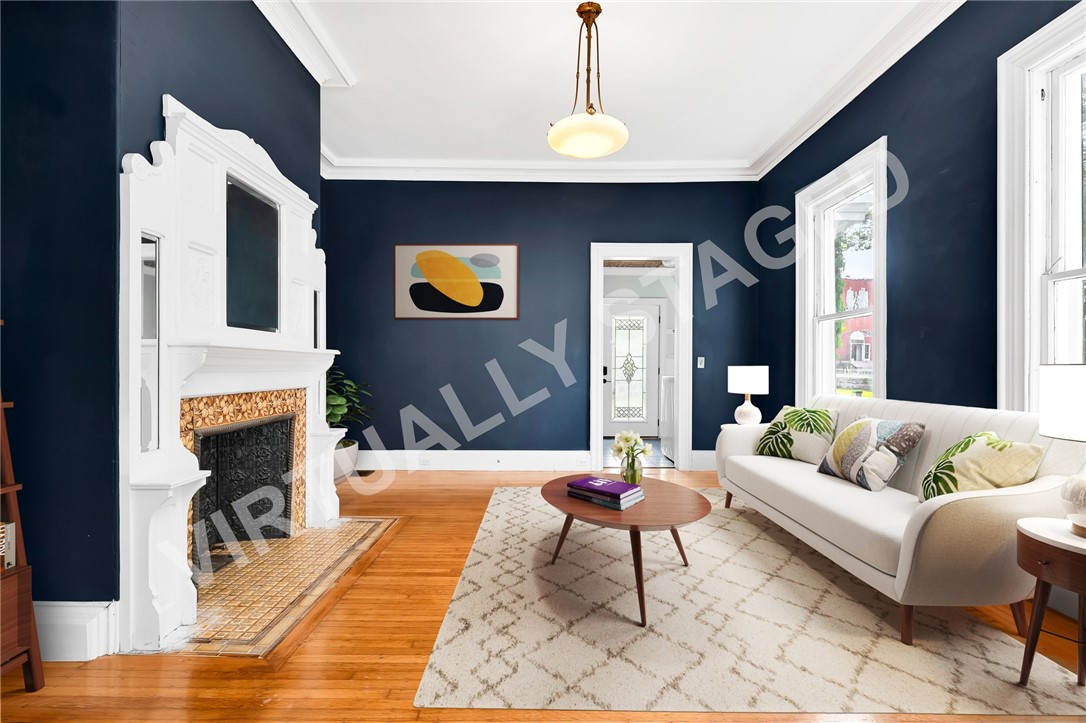 28 Elm Street Westerly, RI 02891 - Photo 8 of 48 AI Staged Living room features a fireplace and beautiful moldings.