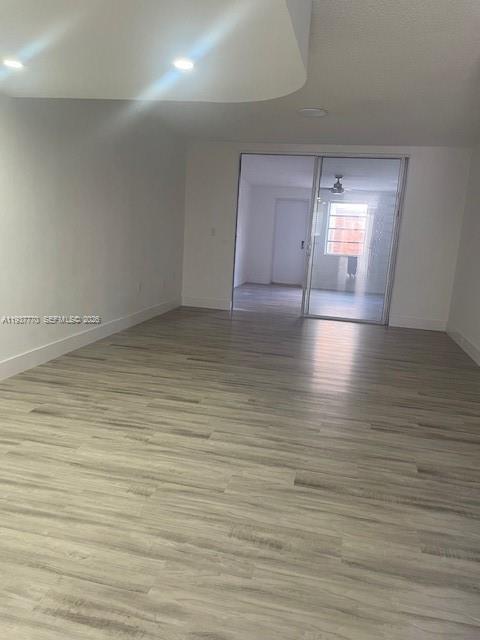 4357 West 11th Lane, Unit 55 Hialeah, FL 33012 - Photo 6 of 17 a view of empty room with wooden floor