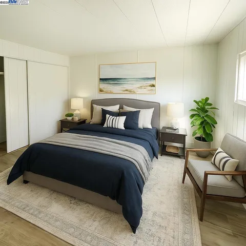 a bedroom with a bed lamp and a potted plant on table