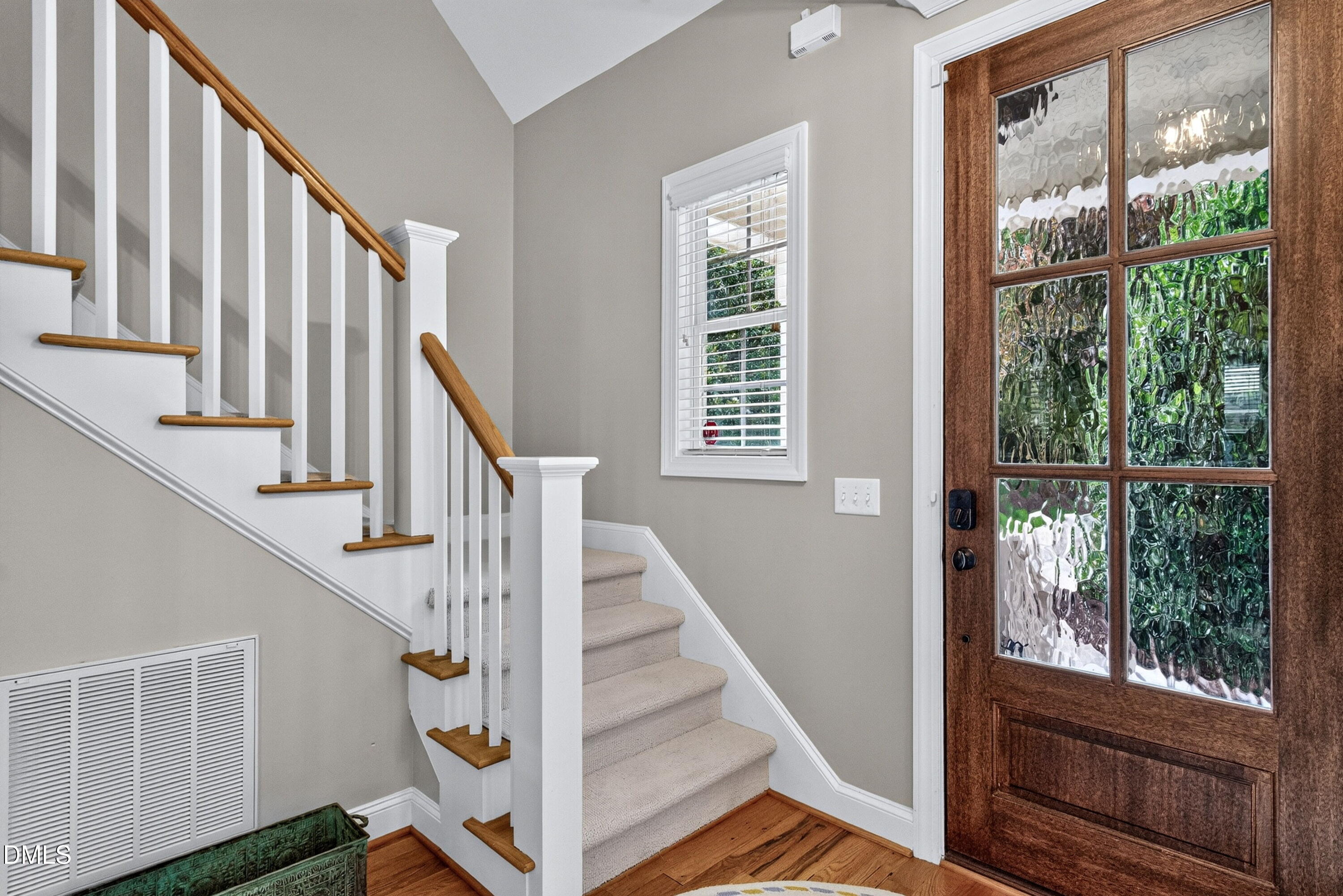 2745 Oberlin Road, Unit 103 Raleigh, NC 27608 - Photo 3 of 23 a view of staircase with wooden floor and front door