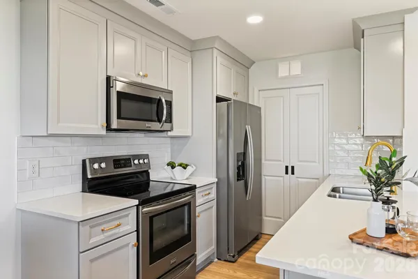 a kitchen with a dining table chairs and view of kitchen