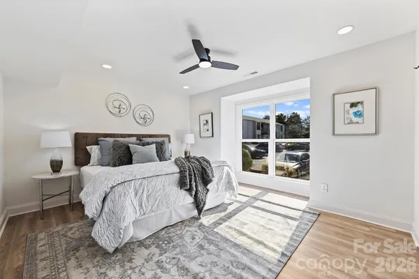 a bedroom with a bed and a large window